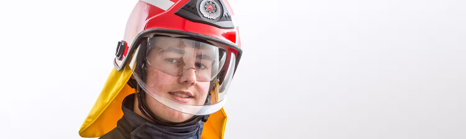 Person wearing a red helmet with clear faceshield, Model F10 MKIII from Pacific Helmets Lakeland