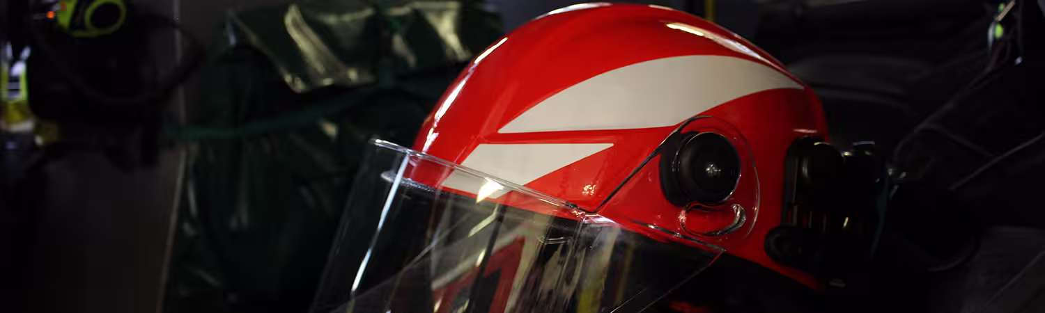 F11 Helmet, Red with White striping standing by itself