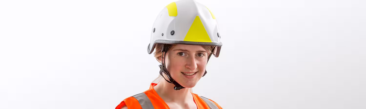 Person wearing a white helmet with yellow reflectors, Model R7H from Pacific Helmets Lakeland